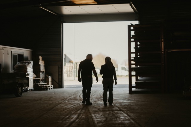 Silhouetted partners walking in warehouse